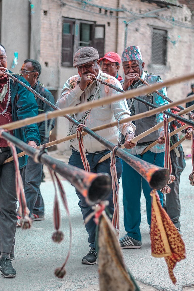 Musicians playing traditional horns in a street parade in Patan, Nepal.